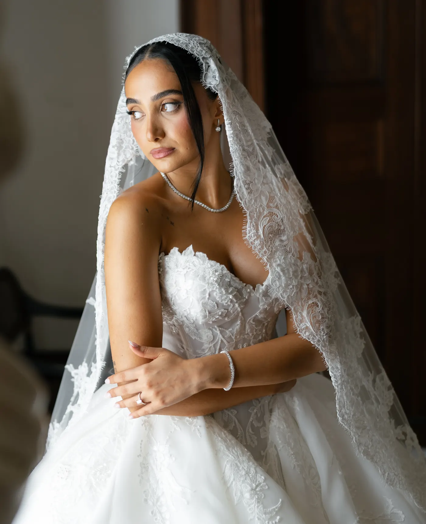 Bride looking over her shoulder with veil