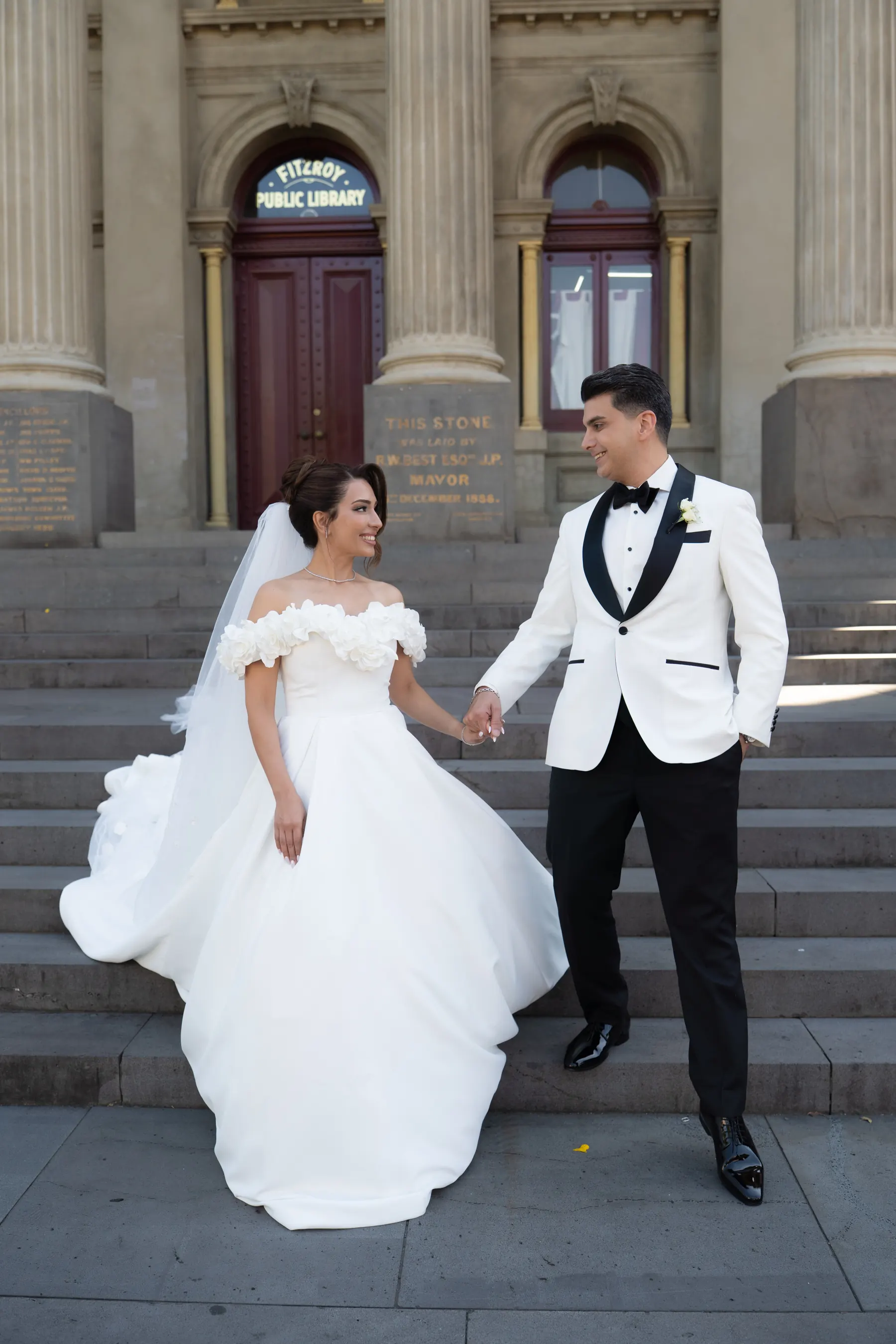 Bride and groom on sandstone steps